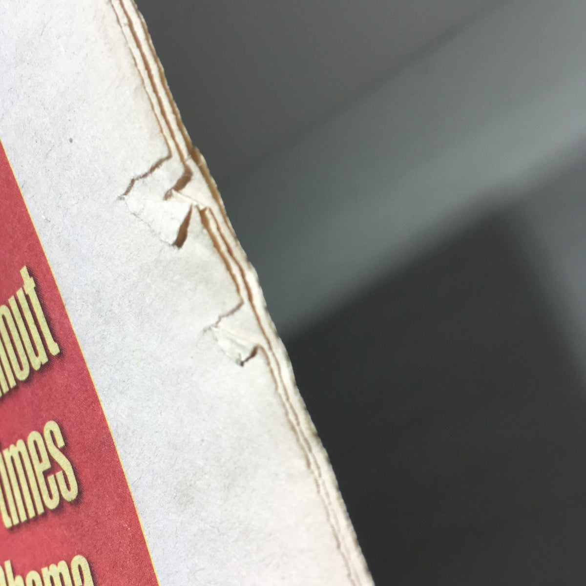 Detailed view of the spine of the New York Daily News from Nov 9, 2008, showing imperfections in the binding, highlighting its vintage condition.