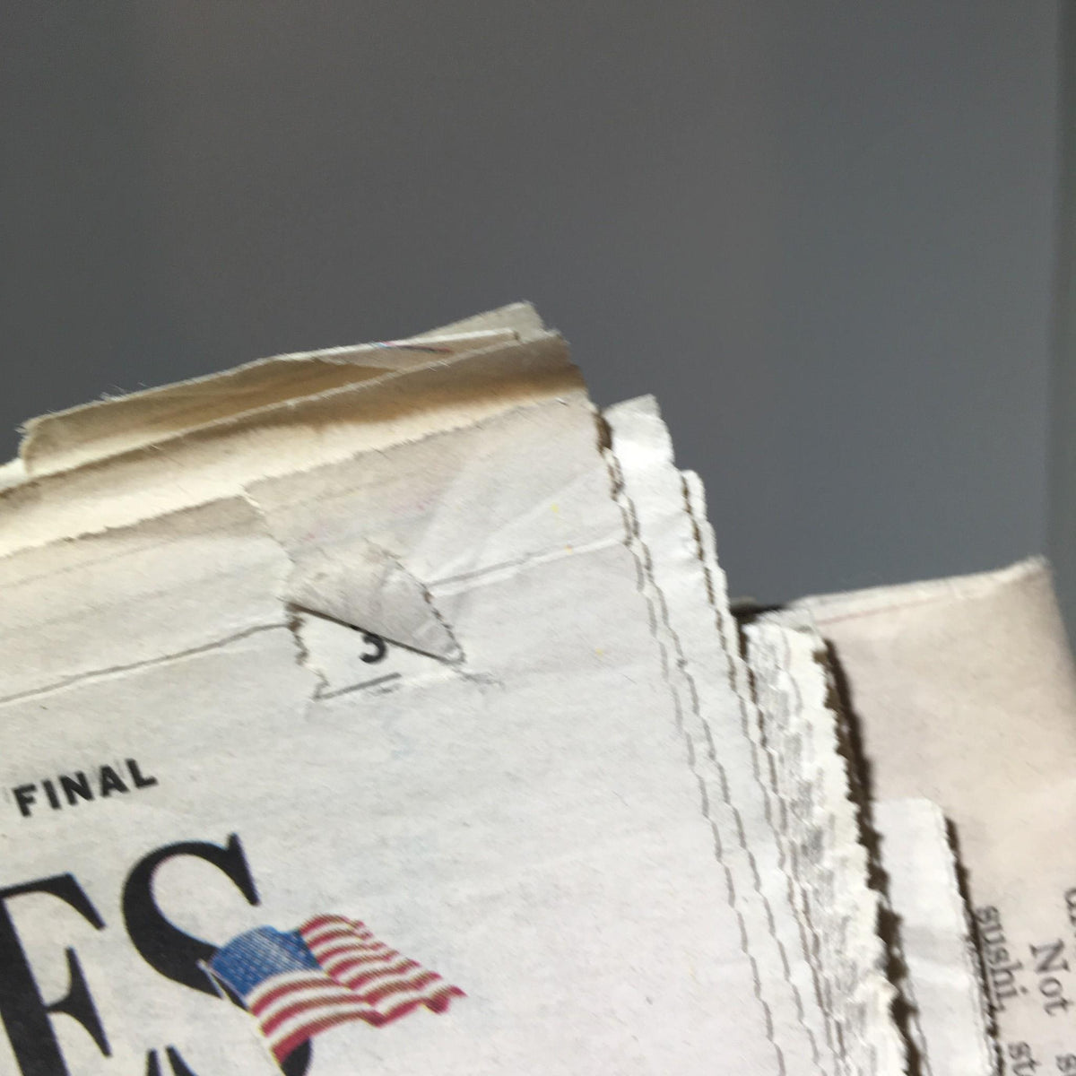 Detail of the edge of the Chicago Sun-Times newspaper featuring minor wear, associated with the Oct 19 2005 edition, titled 'Miers Backed Abortion Ban'.