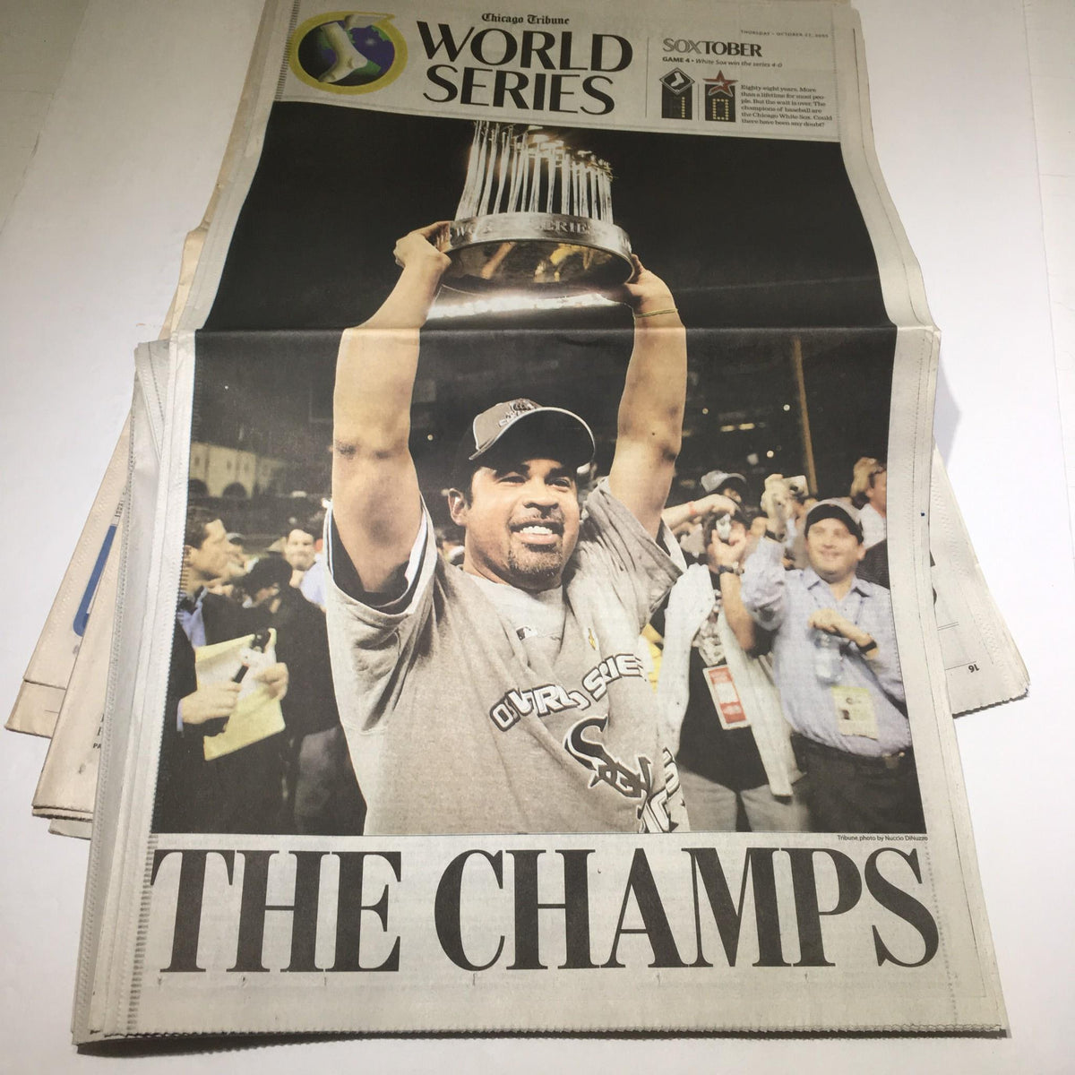 Chicago Tribune cover titled 'THE CHAMPS' celebrating the White Sox victory in the World Series, featuring a player holding the championship trophy.