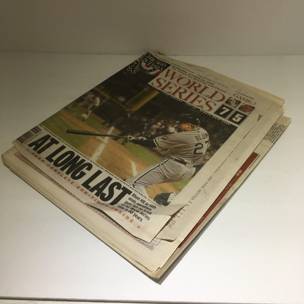 Cover of the Chicago Sun-Times: Oct 26 2005 edition featuring the headline 'At Long Last' along with sports graphics from the World Series. A perfect representation of historical sports journalism.
