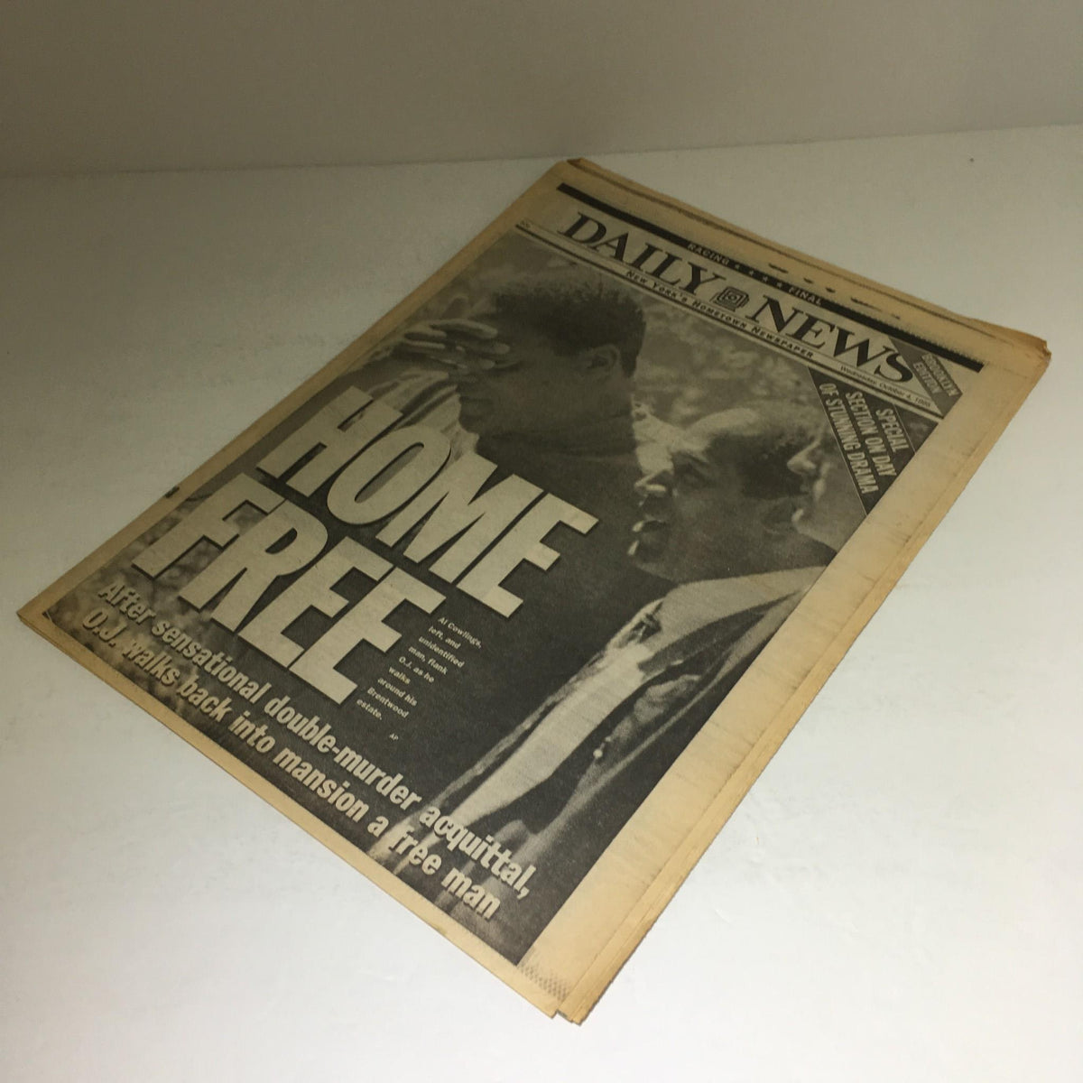 Side perspective of New York Daily News front page from October 4, 1995 with the headline 'HOME FREE' highlighting O.J. Simpson's return home after the trial.