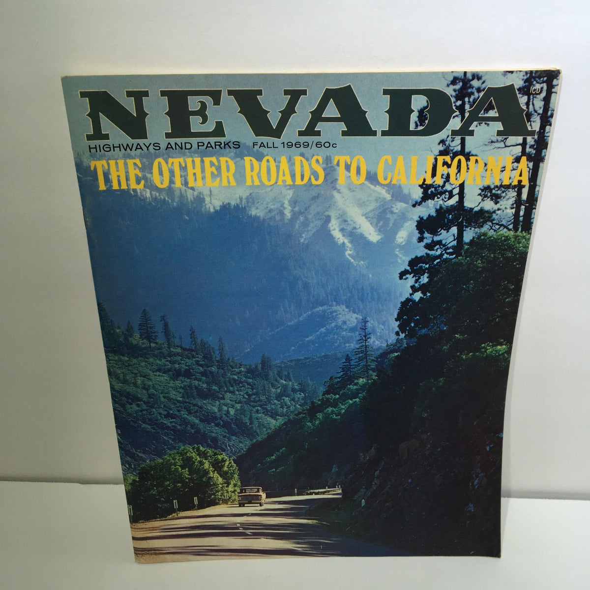 Cover of 'Nevada Highways and Parks Fall 1969 - The Other Roads To California Magazine' featuring a scenic highway through mountains and trees.