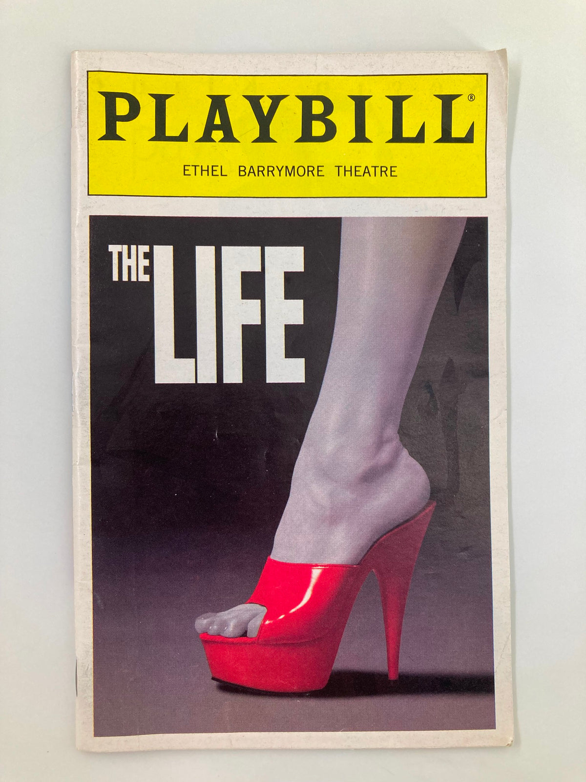 1997 Playbill for The Life at Ethel Barrymore Theatre featuring a striking cover with a red high-heeled shoe.