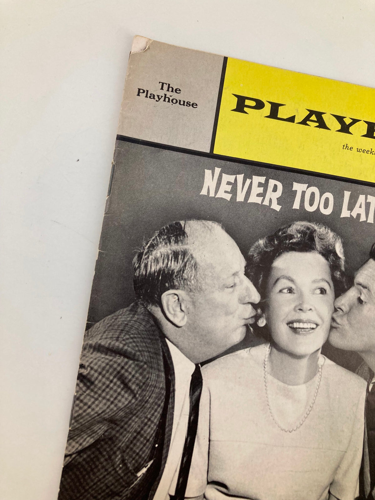 Close-up of the 1963 Playbill for 'Never Too Late,' emphasizing the title and featured actors at The Playhouse.