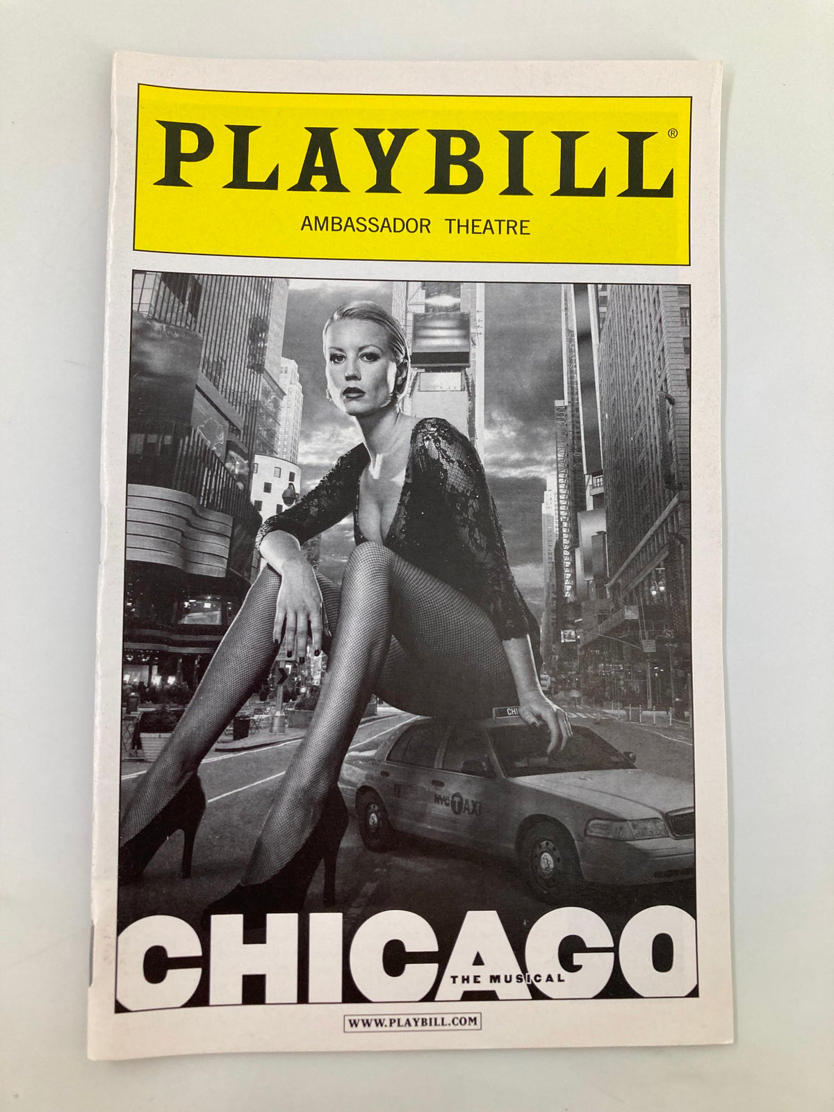 2011 Playbill from Ambassador Theater featuring Kara DioGuardi and Amra-Faye Wright in Chicago, showcasing the iconic musical's cover art with a striking black-and-white image and vibrant yellow title.