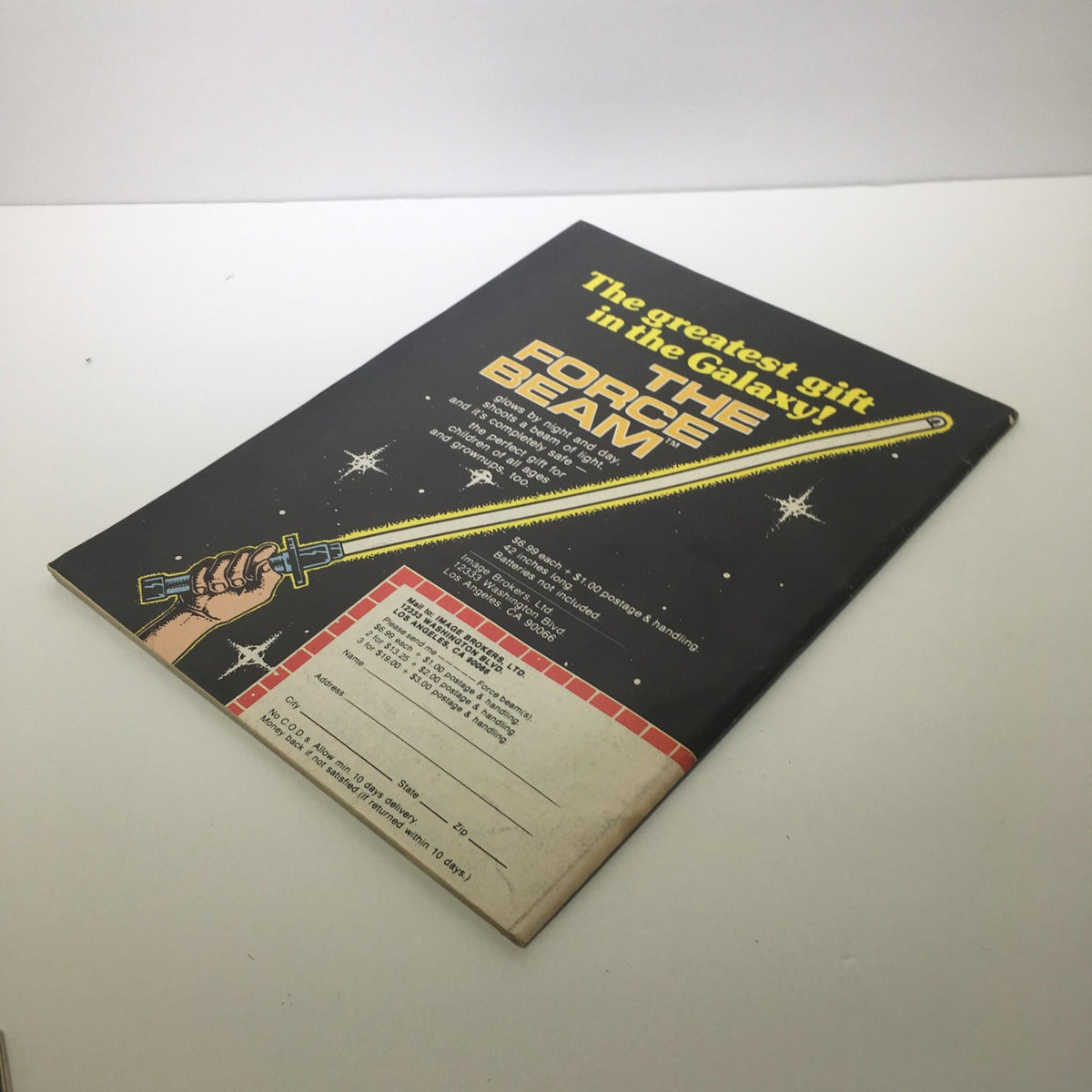 Side view of 'The Force Beam' toy advertisement in Starlog Magazine Number 13, showcasing the product alongside shipping information.