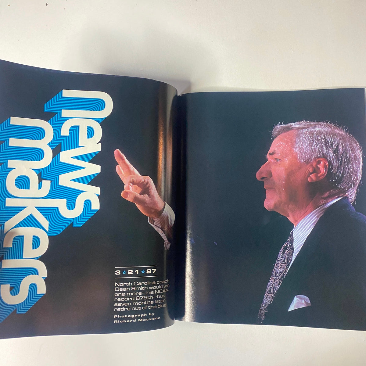 Sports Illustrated Magazine - Tiger Woods YEAR IN PICTURES 1997 showcasing North Carolina coach Dean Smith from a side profile during a press event, emphasizing his iconic presence in college basketball history.