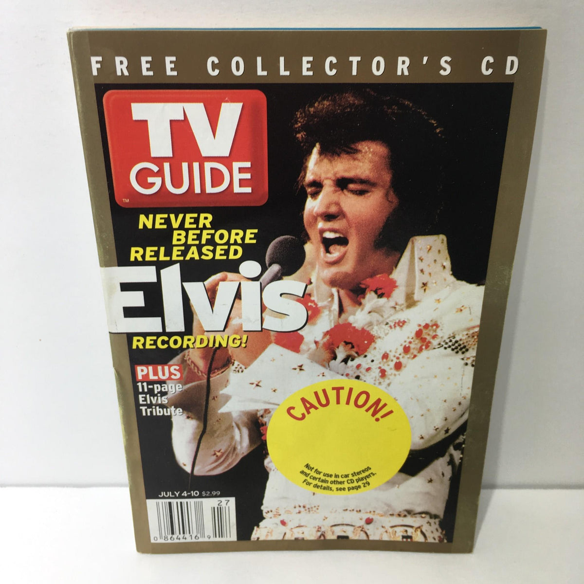 TV Guide July 4-10 2004 featuring Elvis Presley on the cover with a performer holding a microphone. The cover promotes never-before-released Elvis recordings.