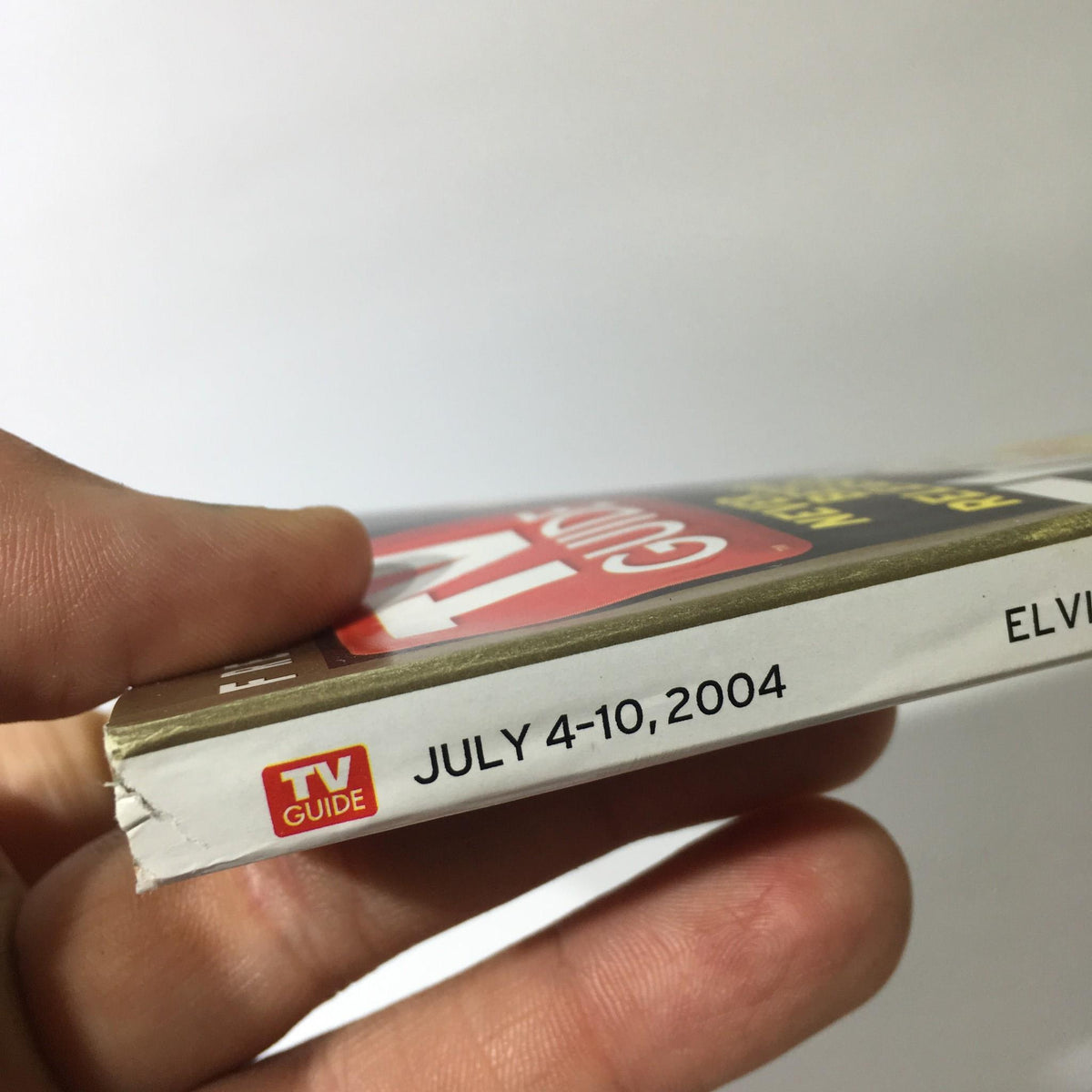 Side view of TV Guide July 4-10 2004 showcasing the publication date with clear visibility of the title 'TV GUIDE' and Elvis Presley.