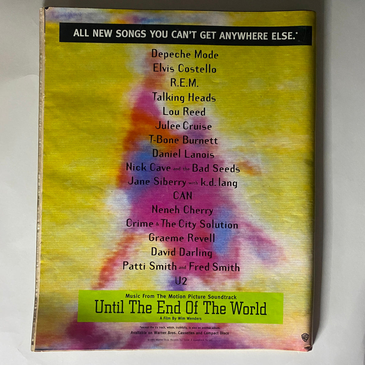 Back cover of Alternative Press Magazine January 1992 No. 44 listing various artists such as Depeche Mode, Elvis Costello, and R.E.M. It emphasizes new music and provides a colorful background, contributing to the magazine's vintage aesthetic.