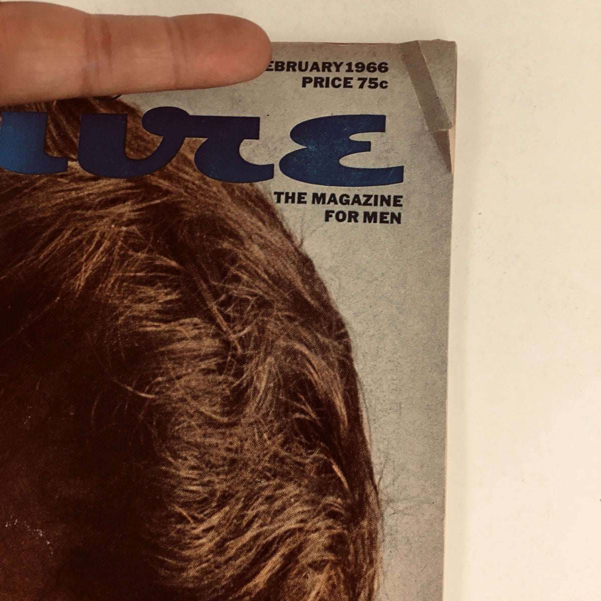 Close-up view of the Esquire Magazine February 1966 top left corner, highlighting the title and price, offering a glimpse into retro magazine design.