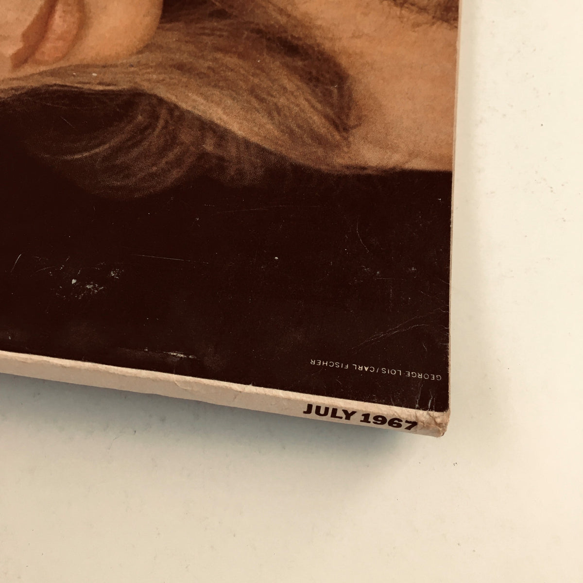 Spine view of Esquire Magazine July 1967 with a date stamp, highlighting the publication's vintage condition.