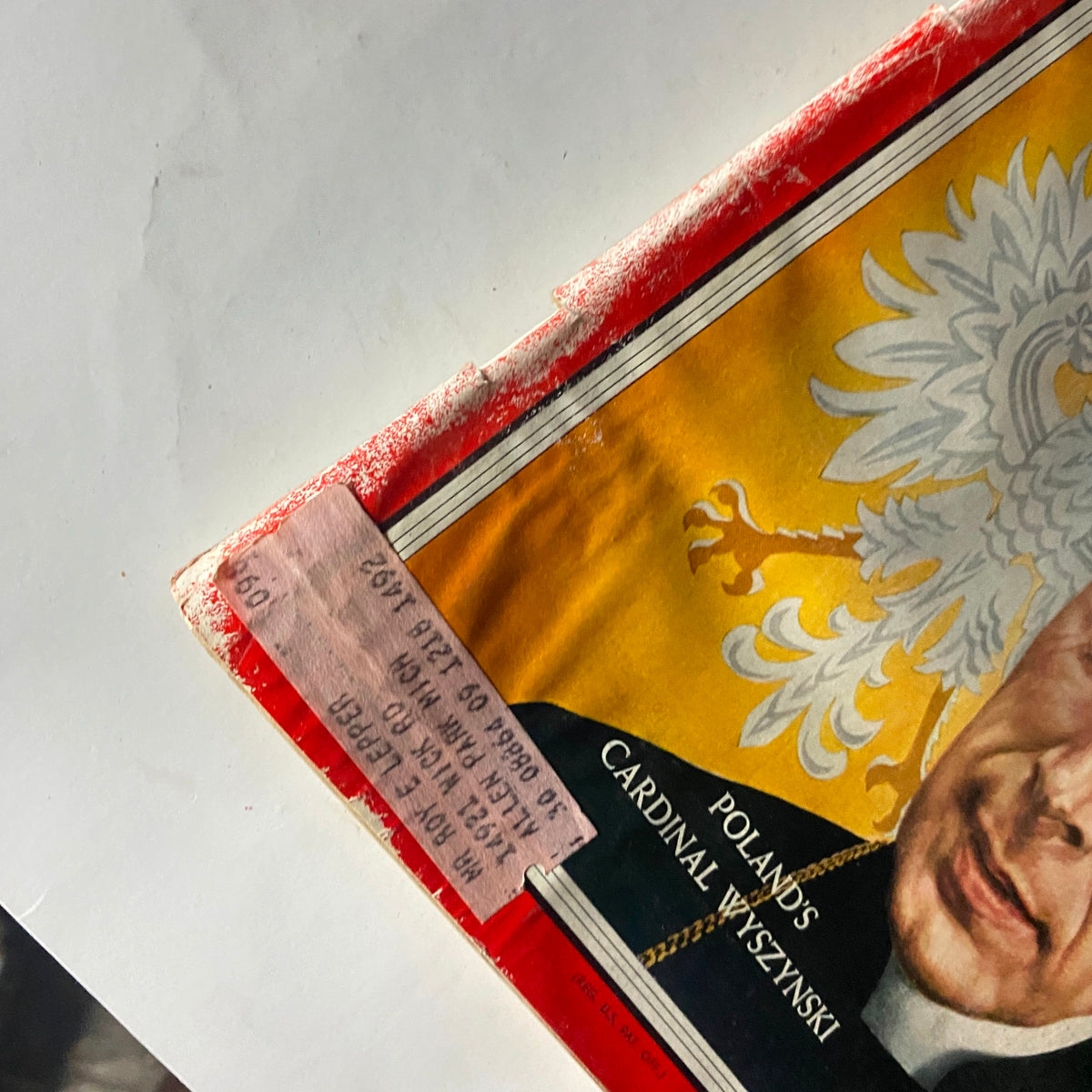 Close-up view of the top edge of VTG Time Magazine May 20, 1957 showcasing a retail tag and remnants of wear.