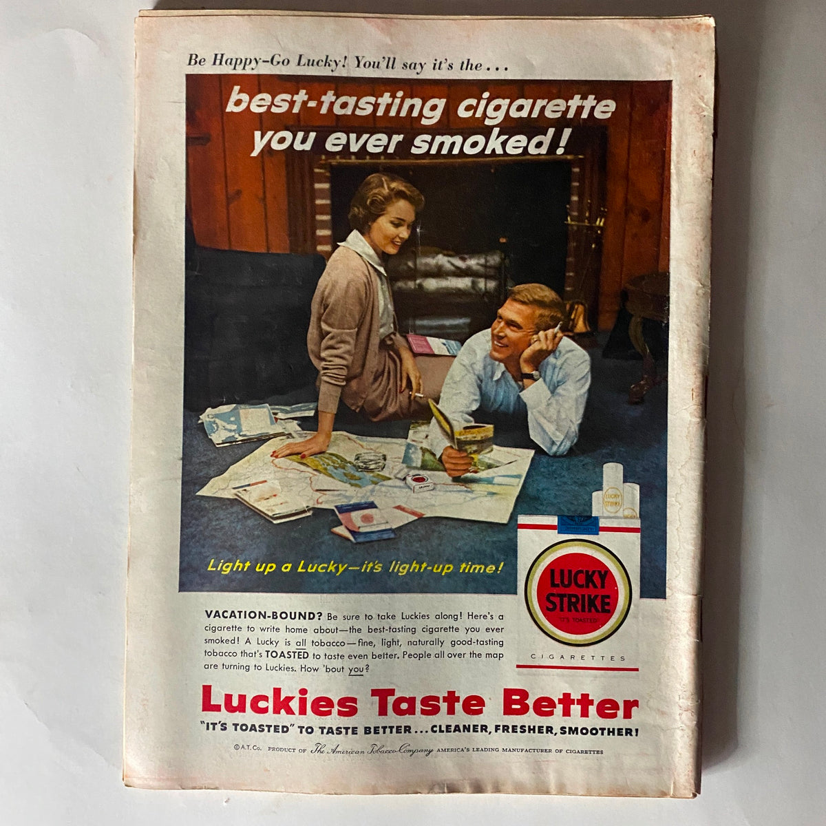 Vintage advertisement in VTG Time Magazine April 1, 1957 promoting Lucky Strike cigarettes, showcasing a friendly couple engaged in conversation while reading.