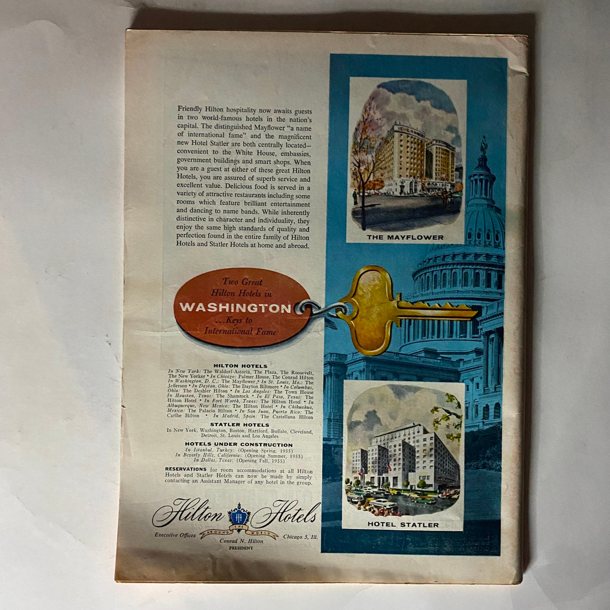 Back cover of Time Magazine from March 21, 1955, showcasing Hilton Hotels advertisement with images and promotional text, relating to the era's travel and hospitality themes.