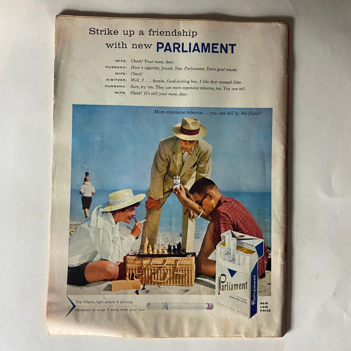 Advertisement from VTG Time Magazine August 5, 1957, promoting Parliament cigarettes with a colorful beach scene and playful characters.