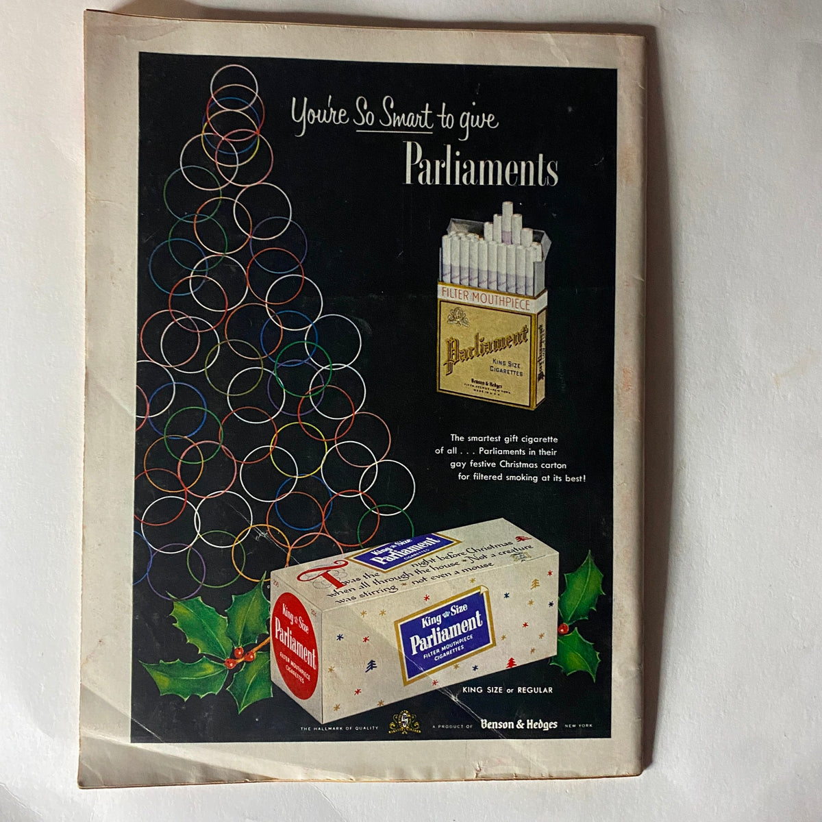 Vintage advertisement for Parliament cigarettes, featured on the back of the VTG Time Magazine December 20, 1954, showcasing a festive design with colorful rings and descriptions of the product, appealing to holiday gift-giving.