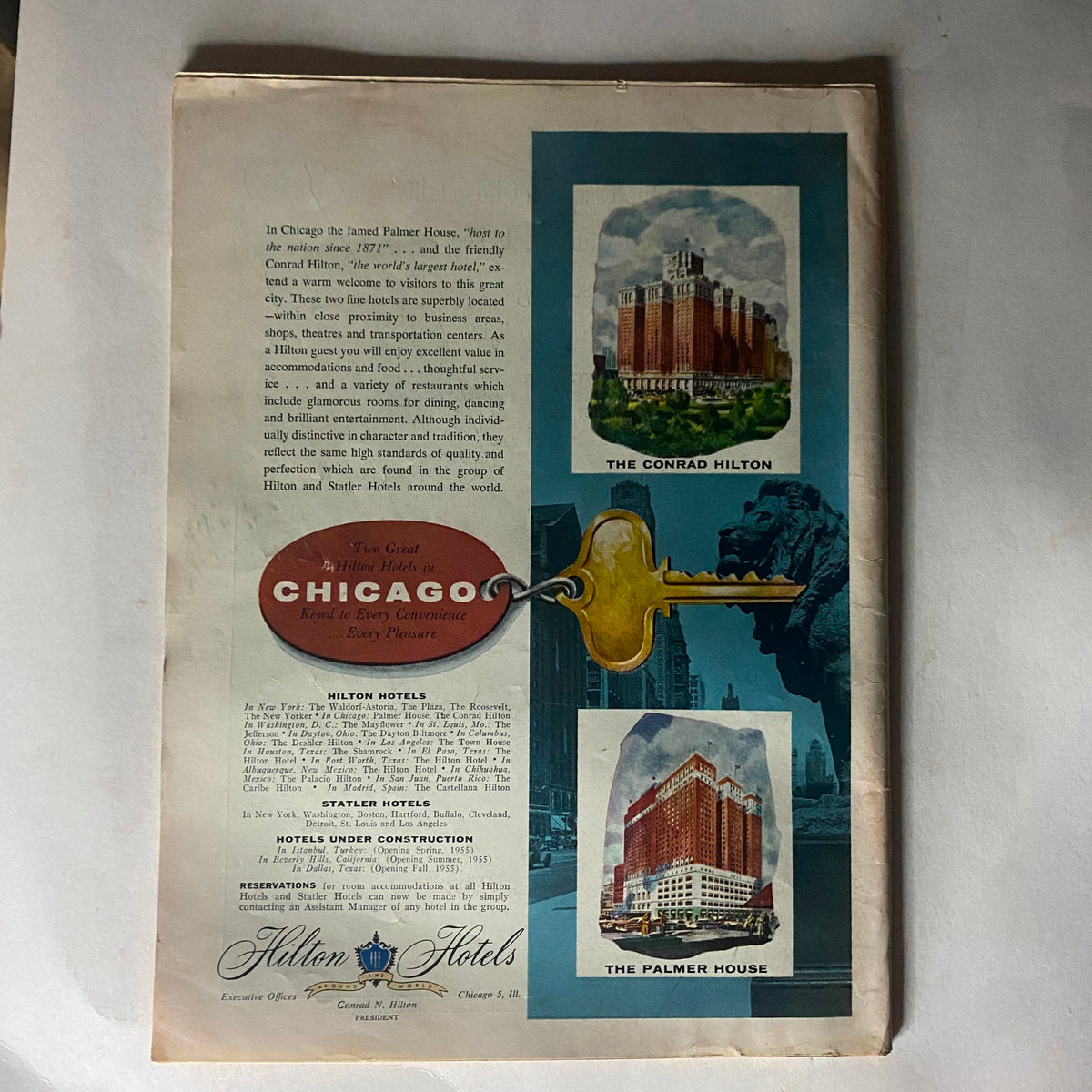 Vintage advertisement for Hilton Hotels in Chicago featured in the VTG Time Magazine February 21, 1955, Vol 65 No. 8 Nikita Khrushchev. The ad showcases The Conrad Hilton and The Palmer House, highlighting their services and accommodations.