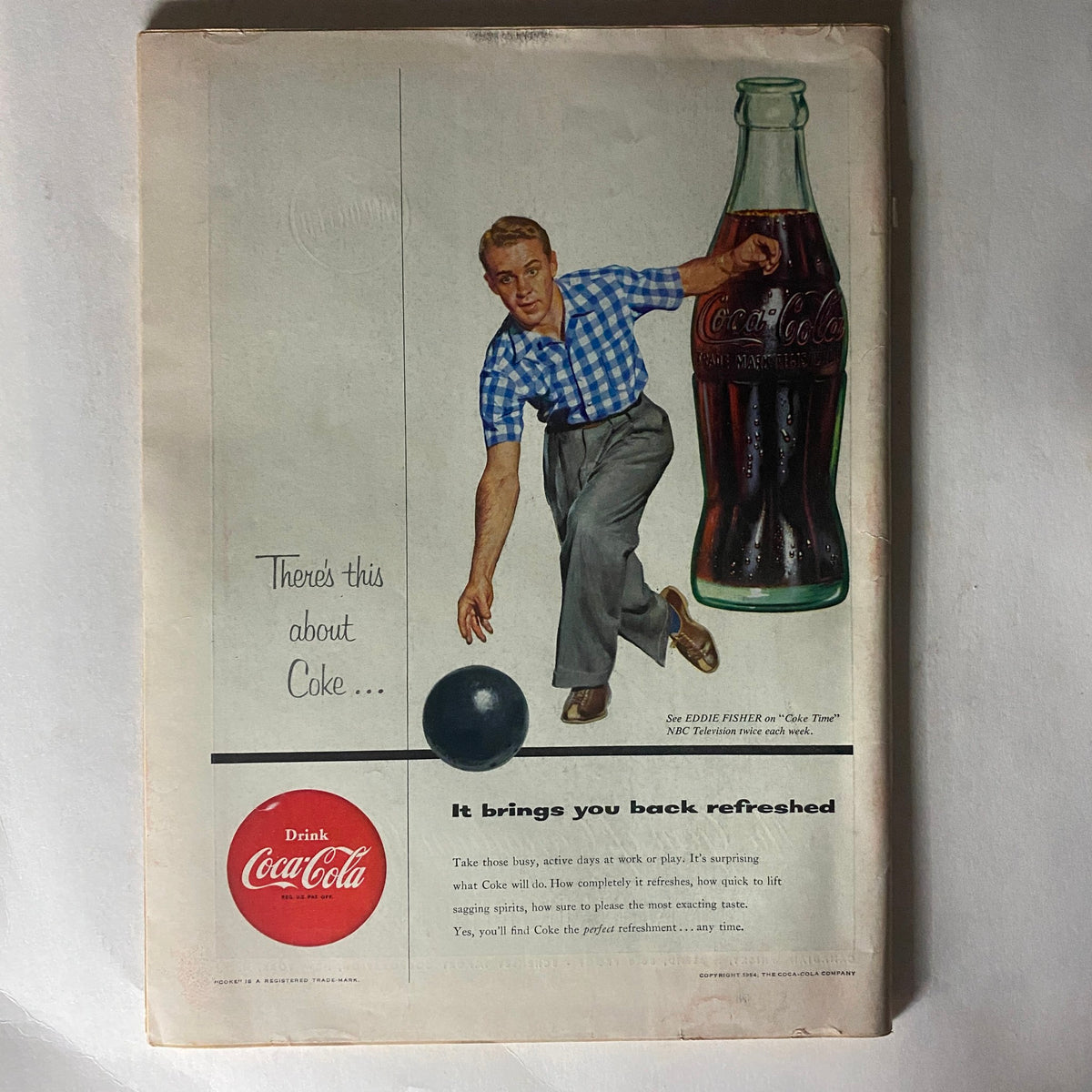 Back cover of the VTG Time Magazine March 15, 1954, featuring an advertisement for Coca-Cola, depicting a man in a blue checkered shirt bowling, promoting the beverage's refreshing qualities.