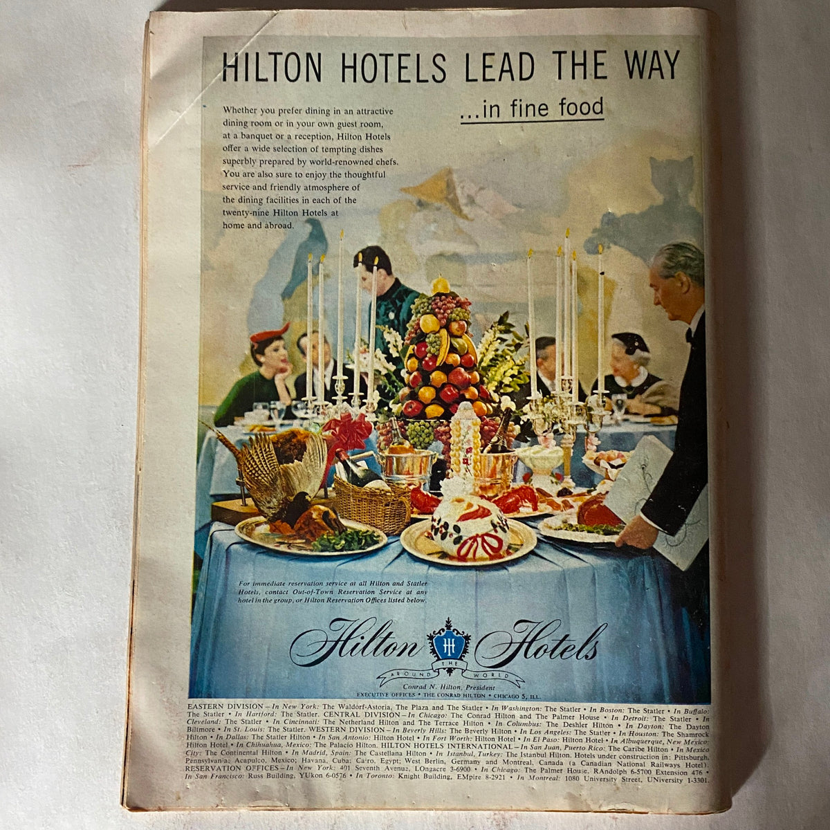Back advertisement page of VTG Time Magazine February 25, 1957 featuring Hilton Hotels, showcasing a fine dining scene with elegant table settings.