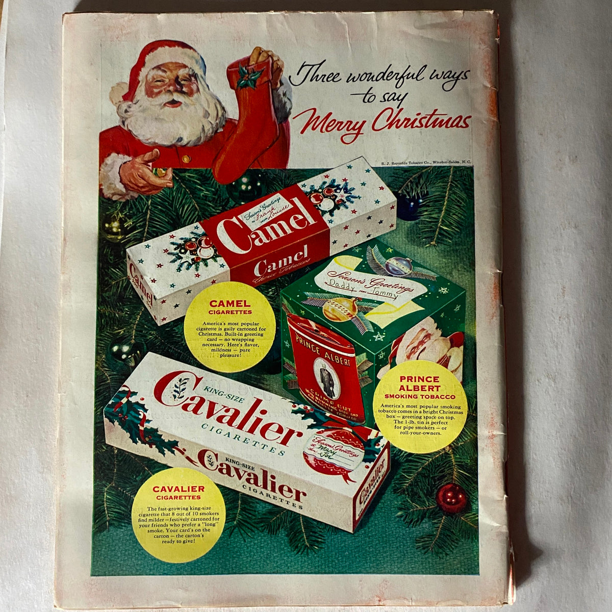 Back cover of VTG Time Magazine December 14, 1953, featuring a Santa Claus illustration and cigarette advertisements for Camel and Cavalier brands.