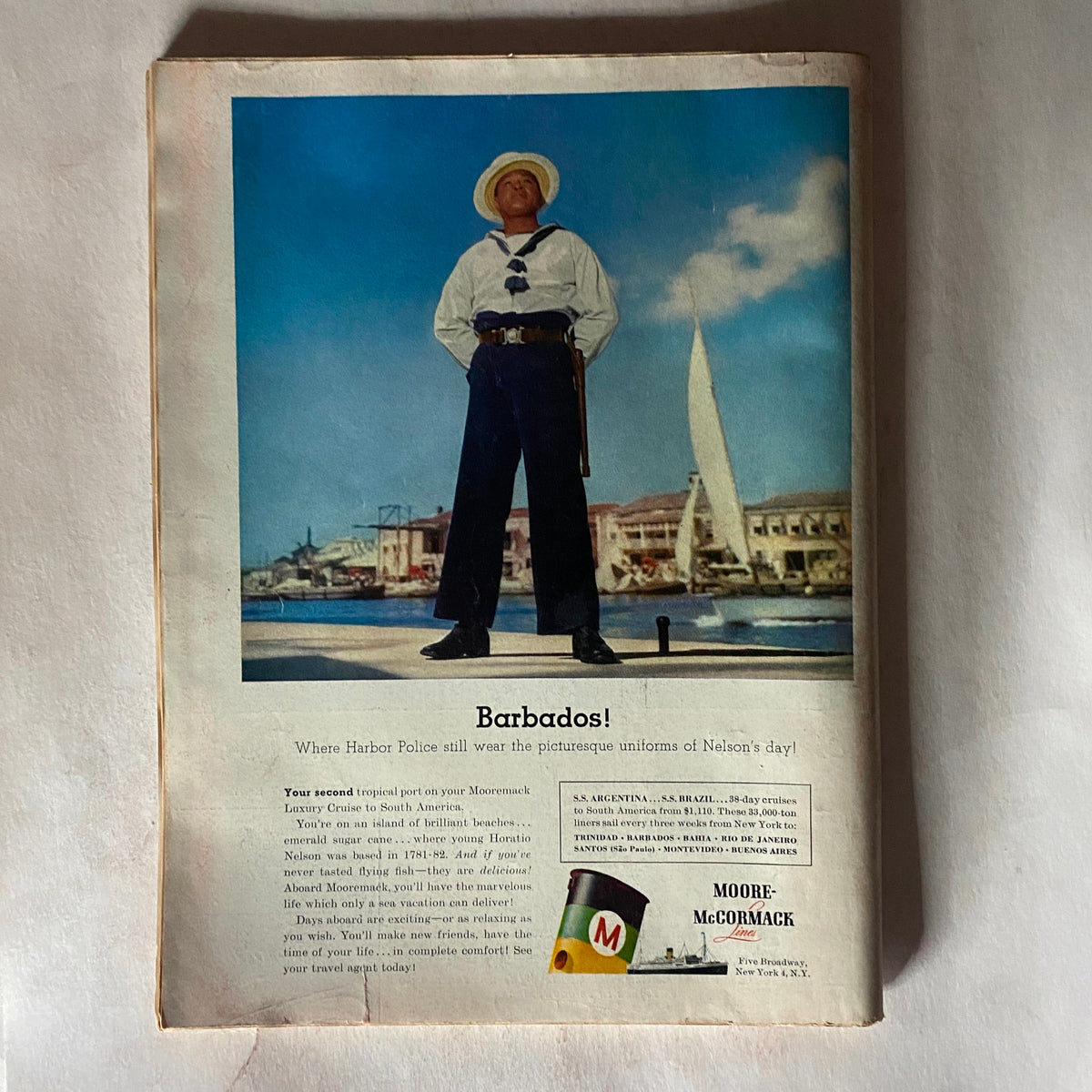 Back cover of the VTG Time Magazine September 10, 1956, featuring an advertisement for Moore-McCormack cruises to Barbados, showcasing a harbor policeman in traditional uniform.