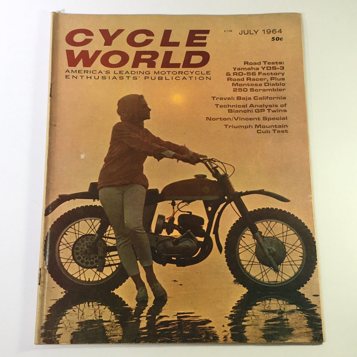 Cover of VTG Cycle World Magazine July 1964 featuring the Yamaha YDS-3 & RD-56 Factory Road Racer, showcasing a woman posing with a motorcycle.