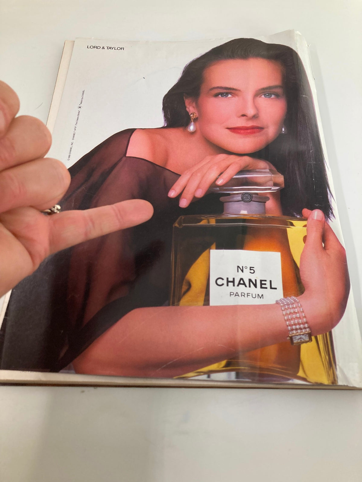 An advert from The New Yorker magazine November 19, 1990 featuring a model promoting Chanel No. 5 perfume, highlighting beauty and fashion from the early '90s.