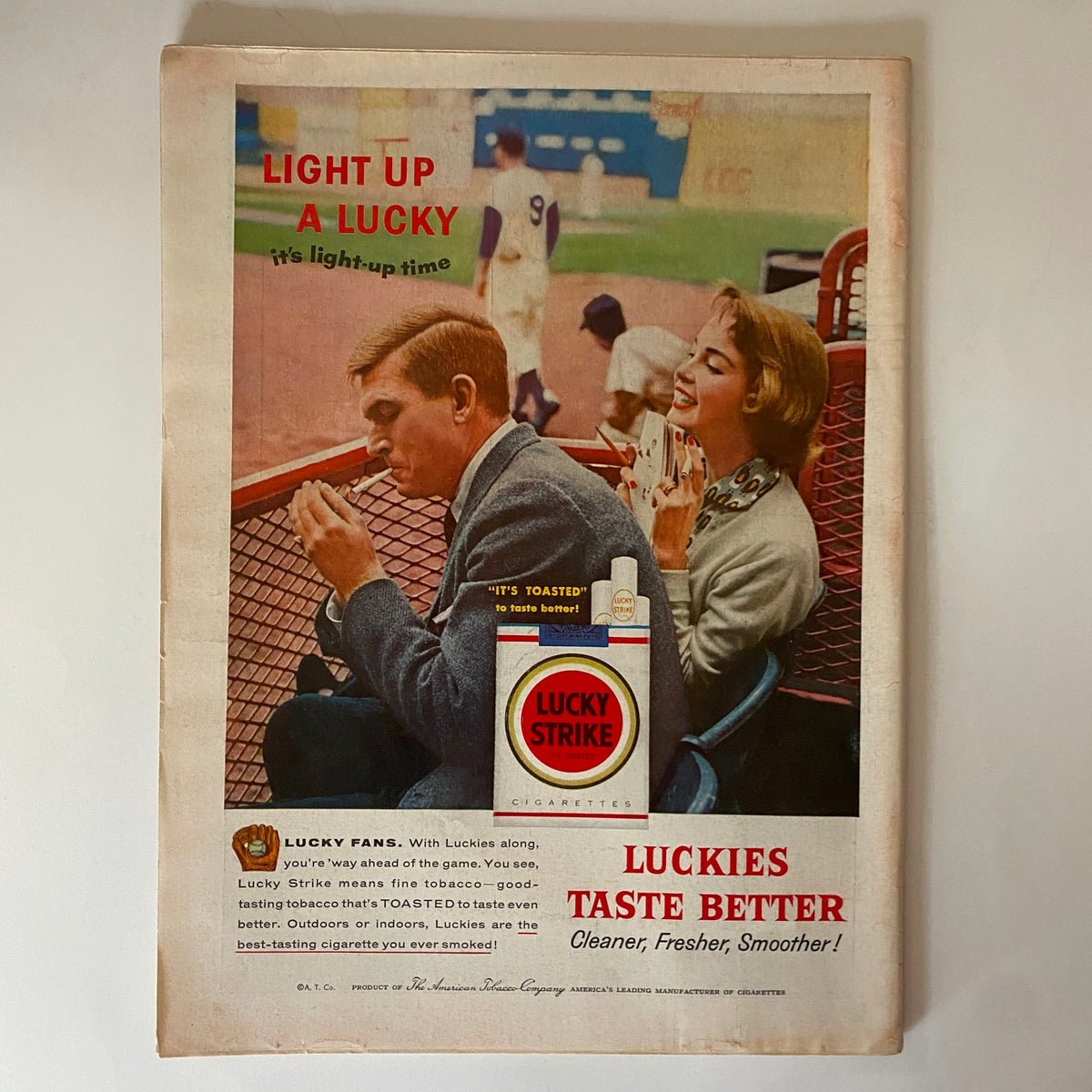 Advertisement in the May 28, 1956 VTG Time Magazine promoting Lucky Strike cigarettes, showcasing a couple at a baseball game.