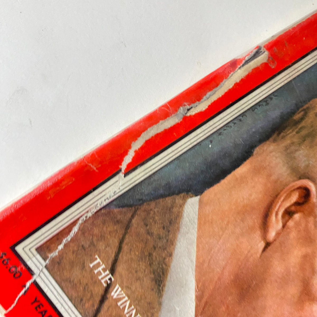 Close-up of a damaged corner on the Vintage Time Magazine cover from November 12, 1956 featuring Dwight D. Eisenhower and Richard Nixon.
