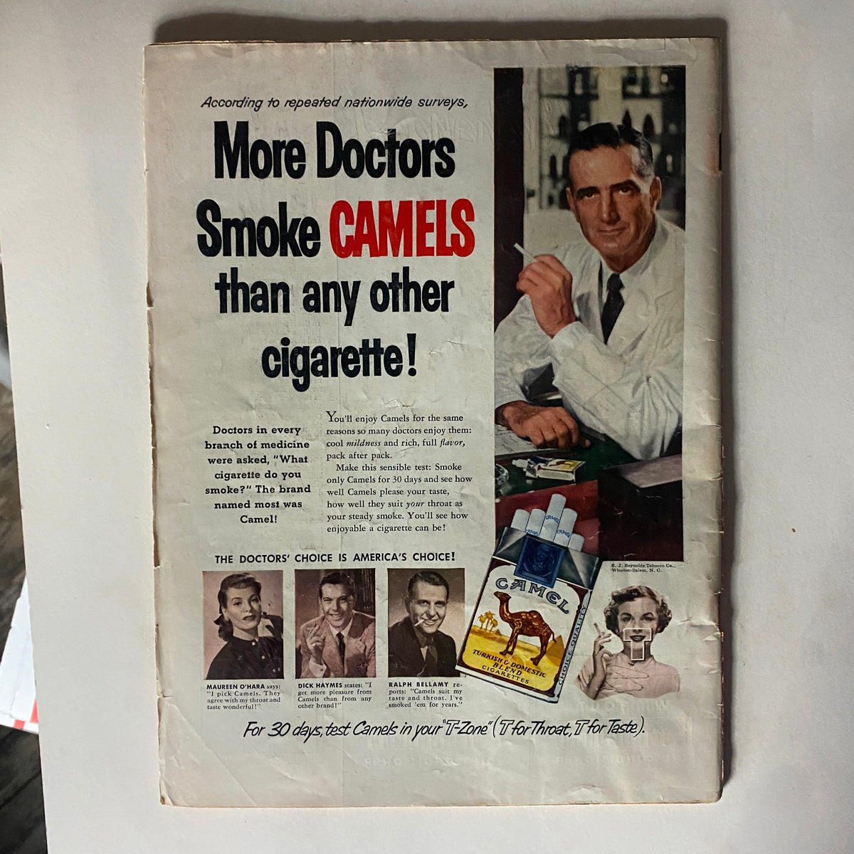 Advertisement from the Vintage Time Magazine July 28, 1952, promoting Camel cigarettes with a doctor endorsing the brand, highlighting historical advertising practices.