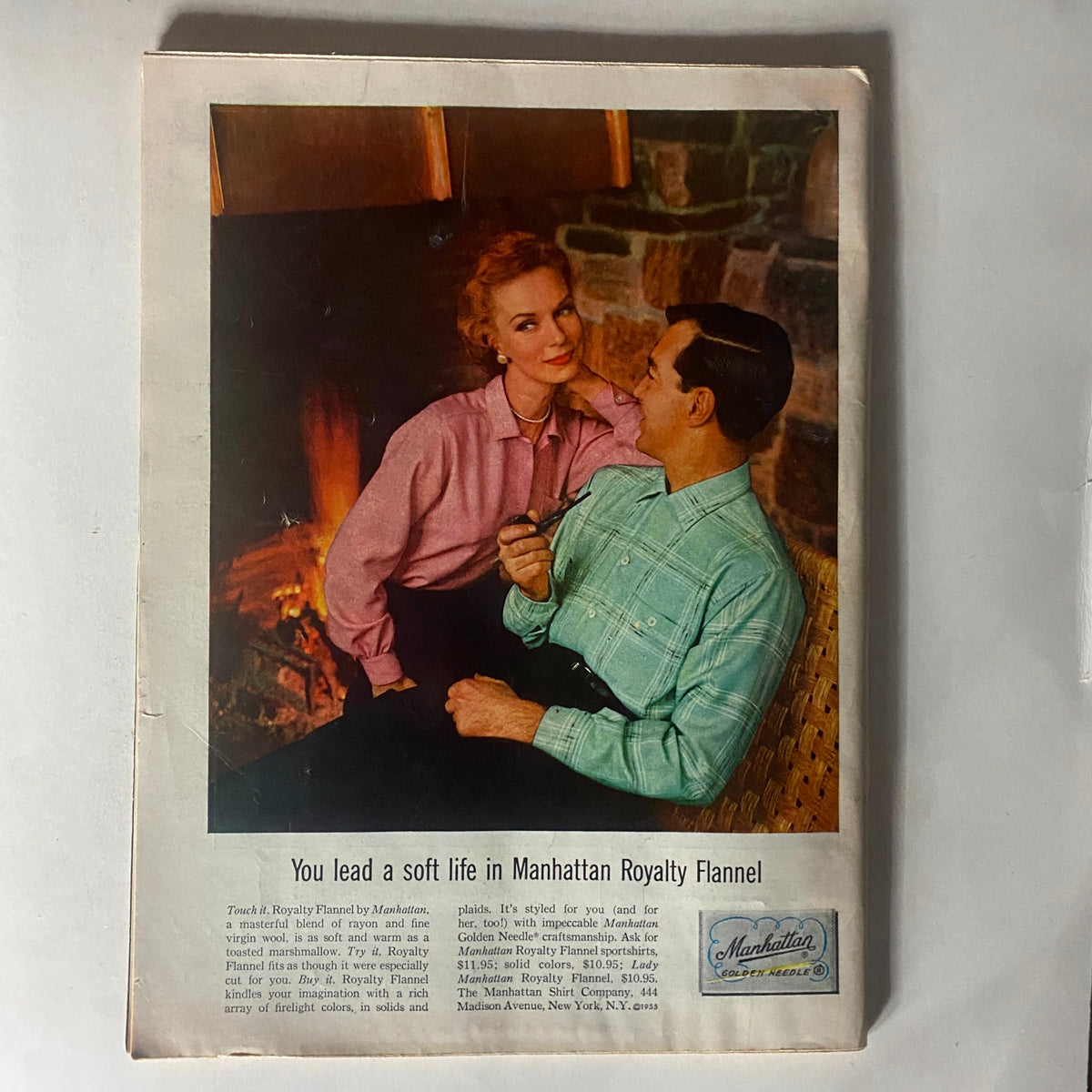 Vintage advertisement featuring a couple enjoying a cozy moment by the fireplace with Manhattan Royalty Flannel, in the VTG Time Magazine November 28, 1955, Vol 66 No. 22 with Julie Harris as Joan of Arc on the cover.