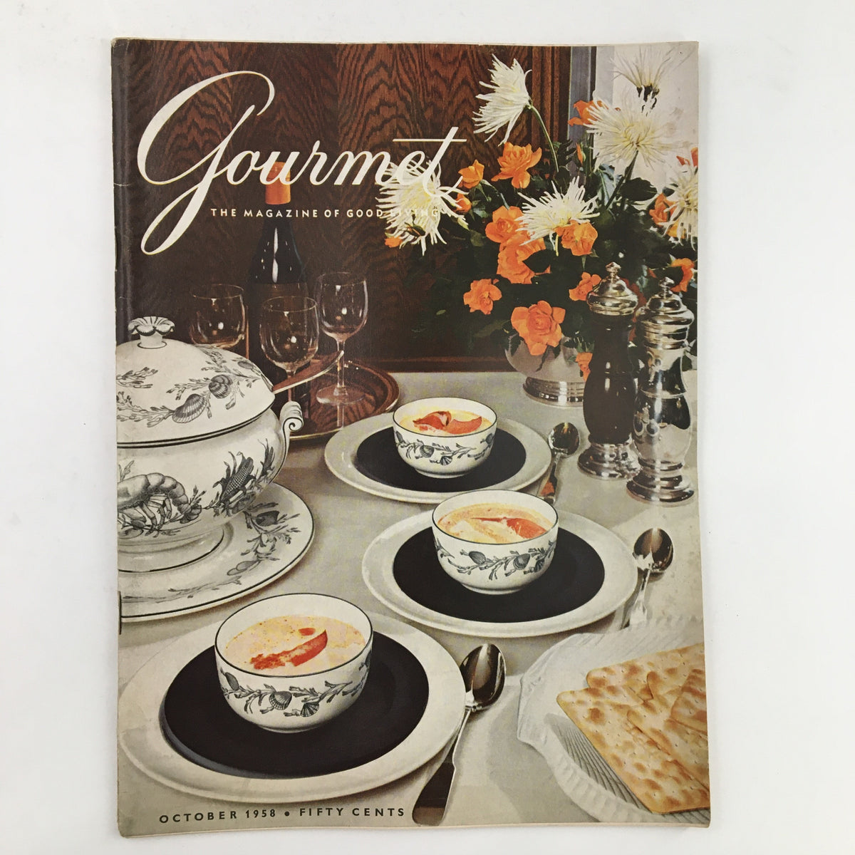Cover of Gourmet Magazine October 1958 Vol. 18 No. 10 featuring elegant dining setup with soup bowls, a floral centerpiece, and fine tableware, categorized as 'The Kindest Cuts Beefsteak.'