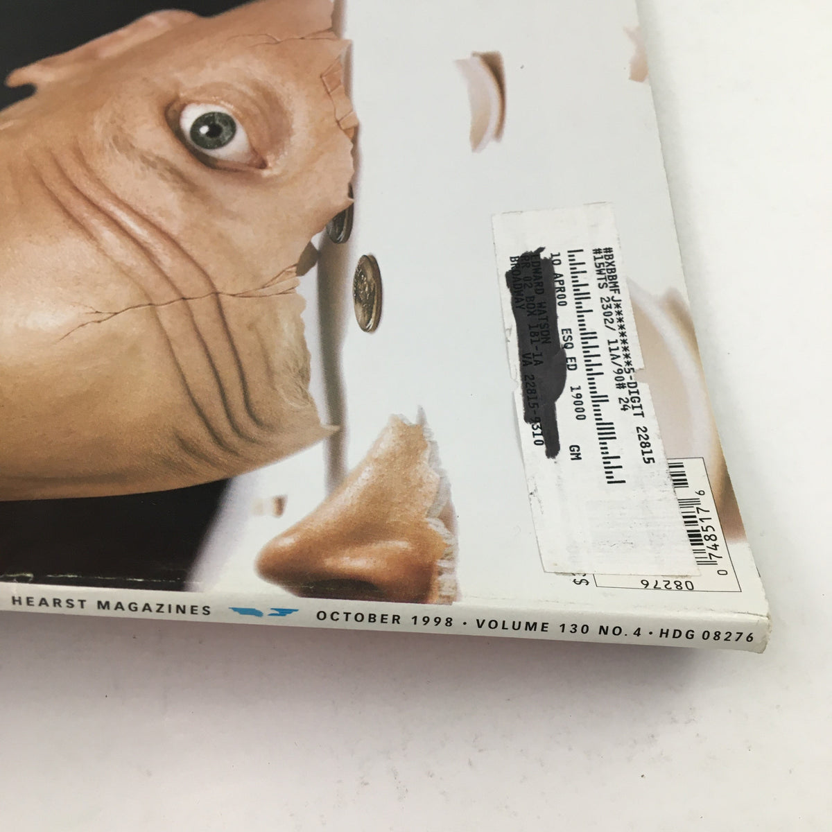Side view of Esquire Magazine October 1998 showcasing the unique cover design with details of the magazine's issue number and publication date. The cover art includes a surreal representation of a cracked face and coins.