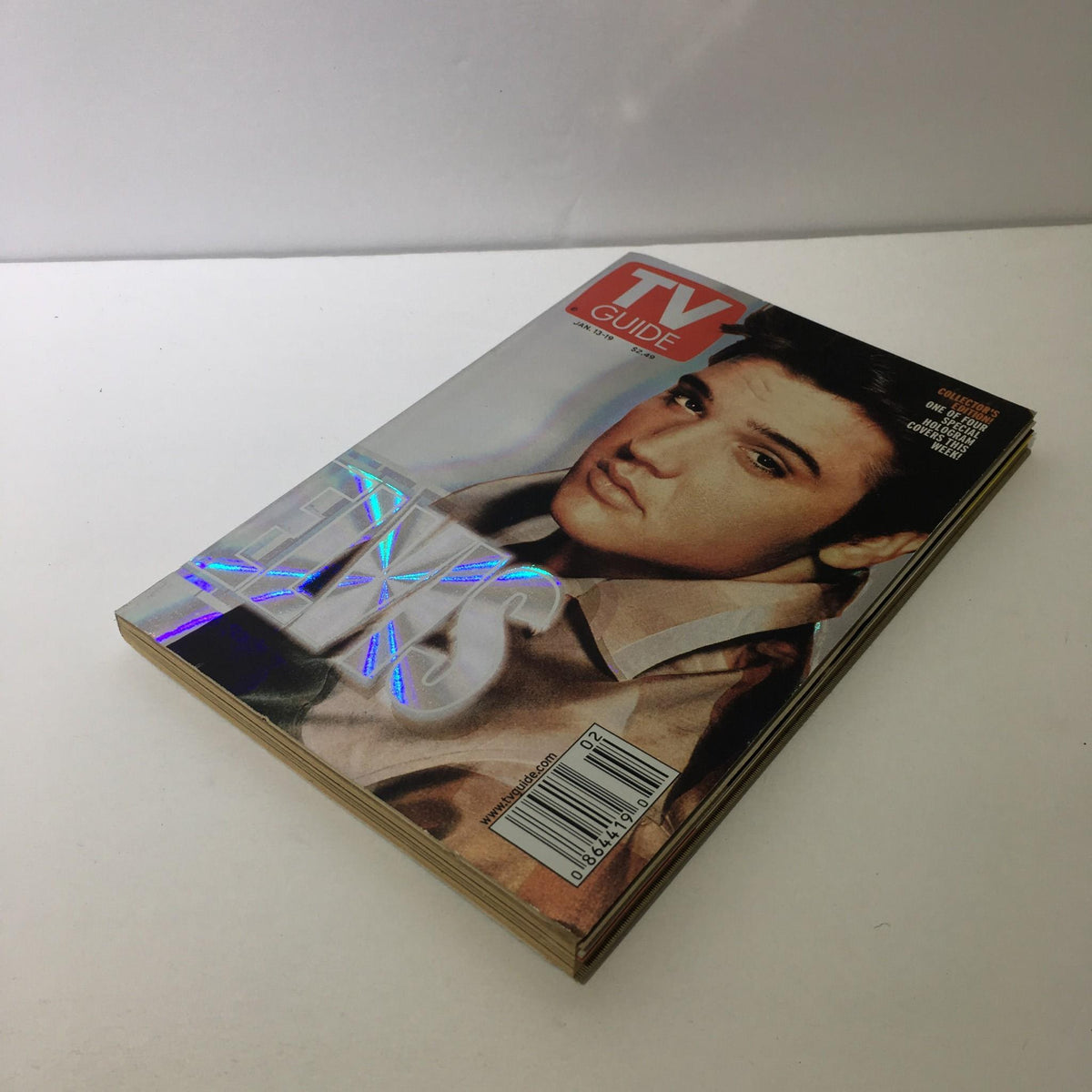 TV Guide from January 13-19, 2001 featuring a holographic cover design with Elvis Presley. This magazine is in excellent condition and has been maintained in a pet-free and smoke-free environment.