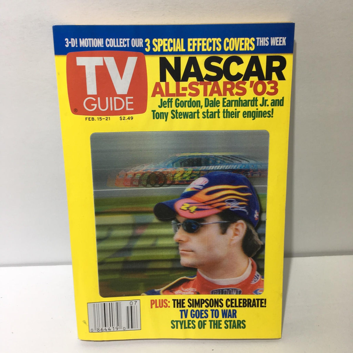 TV Guide February 15-21 2003 featuring Nascar All-Star '03 with Jeff Gordon on the cover, showcasing vibrant colors and racing graphics.
