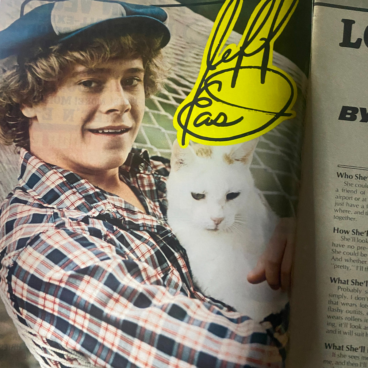Photograph of Jeff East holding a white cat, accompanied by his signature, featured in 16 Magazine August 1974.