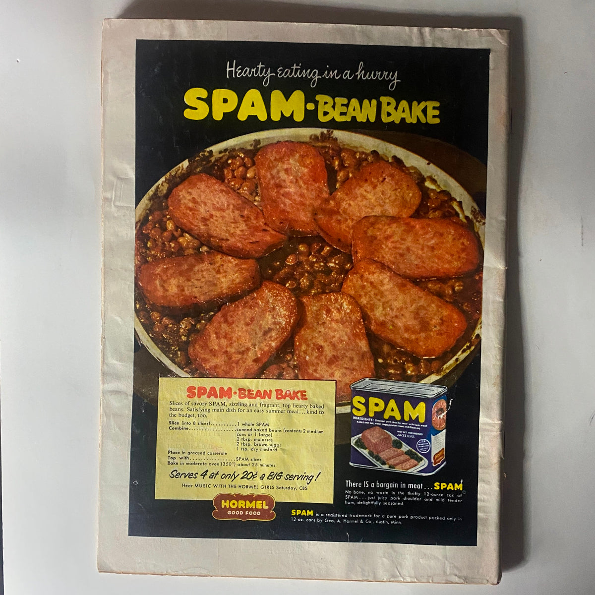 Vintage advertisement for SPAM-Bean Bake from Time Magazine July 21, 1952, featuring a hearty dish with slices of SPAM, beans, and a recipe suggestion.