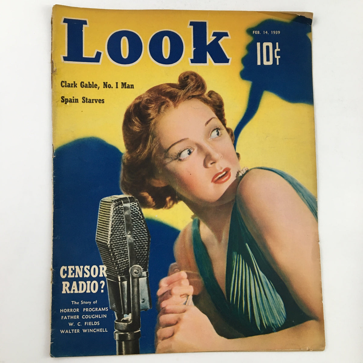 Cover of Look Magazine February 14, 1939 featuring Clark Gable and Luana Walters. The vintage magazine showcases a woman with curly hair looking surprised, with a vintage microphone in the foreground, offering a glimpse into classic Hollywood charm.