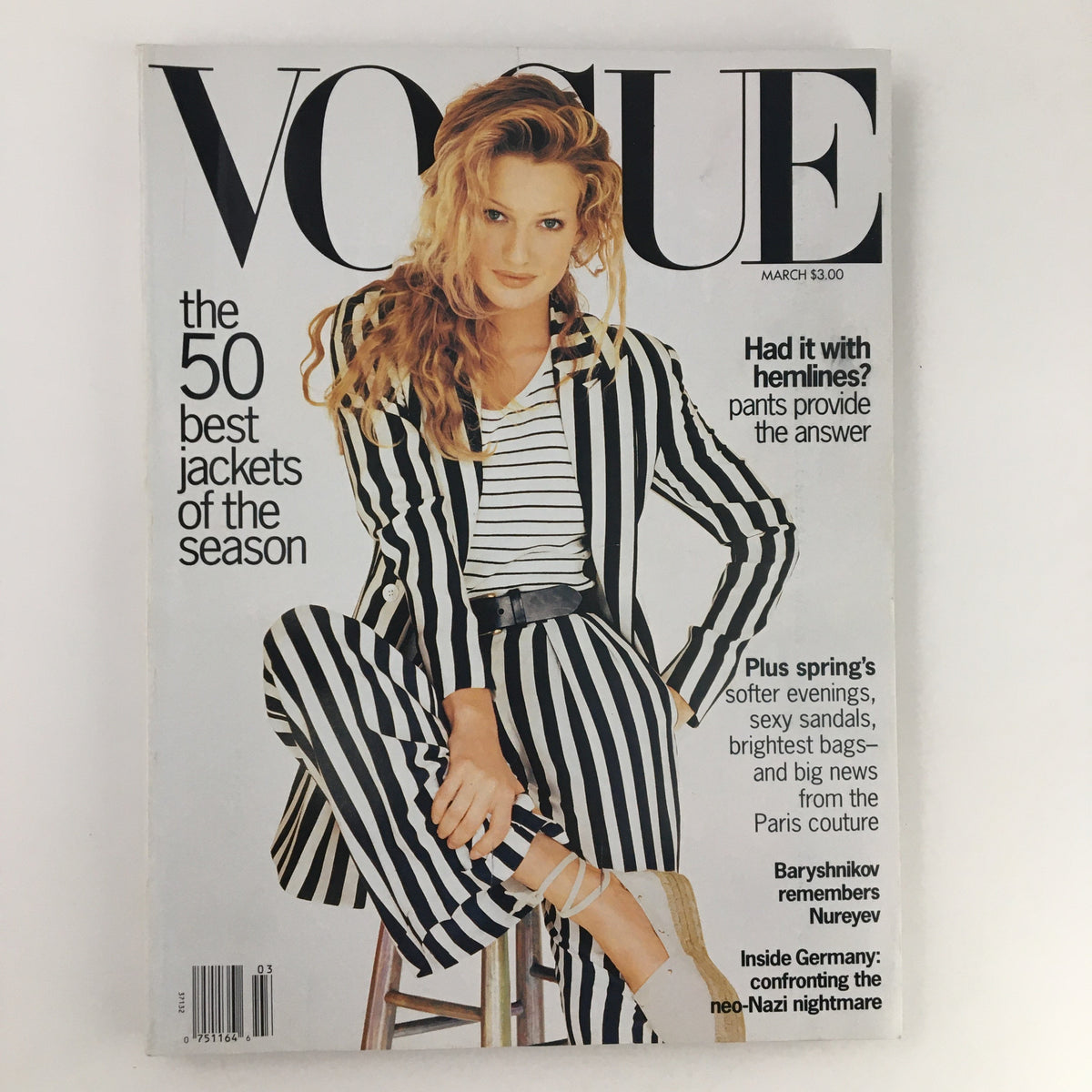 Vogue Magazine March 1993 Cover featuring Karen Mulder in a stylish striped suit, highlighting the 50 best jackets of the season with the issue's title prominently displayed.