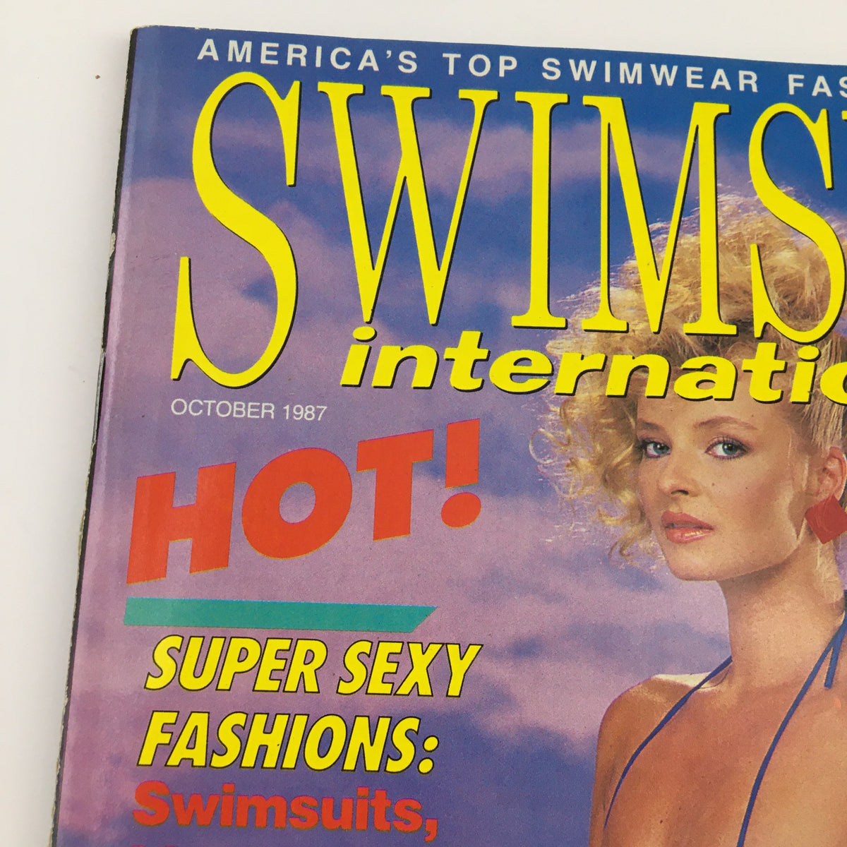 Cover of Swimsuit International Magazine, October 1987, featuring vibrant graphics and the headline 'HOT! SUPER SEXY FASHIONS: Swimsuits'. The model showcases a bikini and highlights the magazine's focus on swimwear.