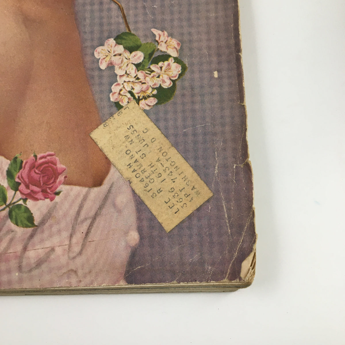 Detailed look at the corner of Ladies' Home Journal Magazine, June 1954, highlighting the magazine's elegant floral design and a tag with text, preserving the nostalgia from the 1950s.