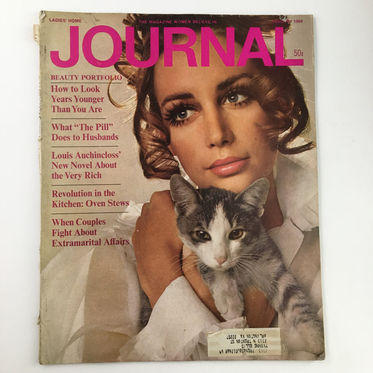 Cover of Ladies' Home Journal Magazine January 1969 featuring a woman with beautiful curls holding a cat, showcasing Louis Auchincloss' novel about the rich.