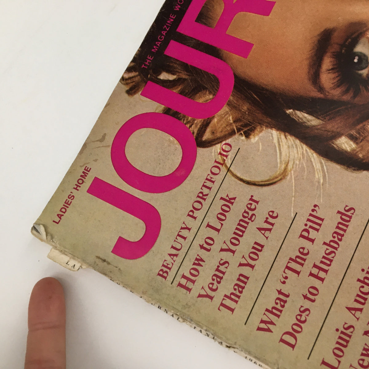 Close-up shot of the Ladies' Home Journal Magazine January 1969 cover with visible text about beauty portfolio and articles, including Louis Auchincloss' novel.