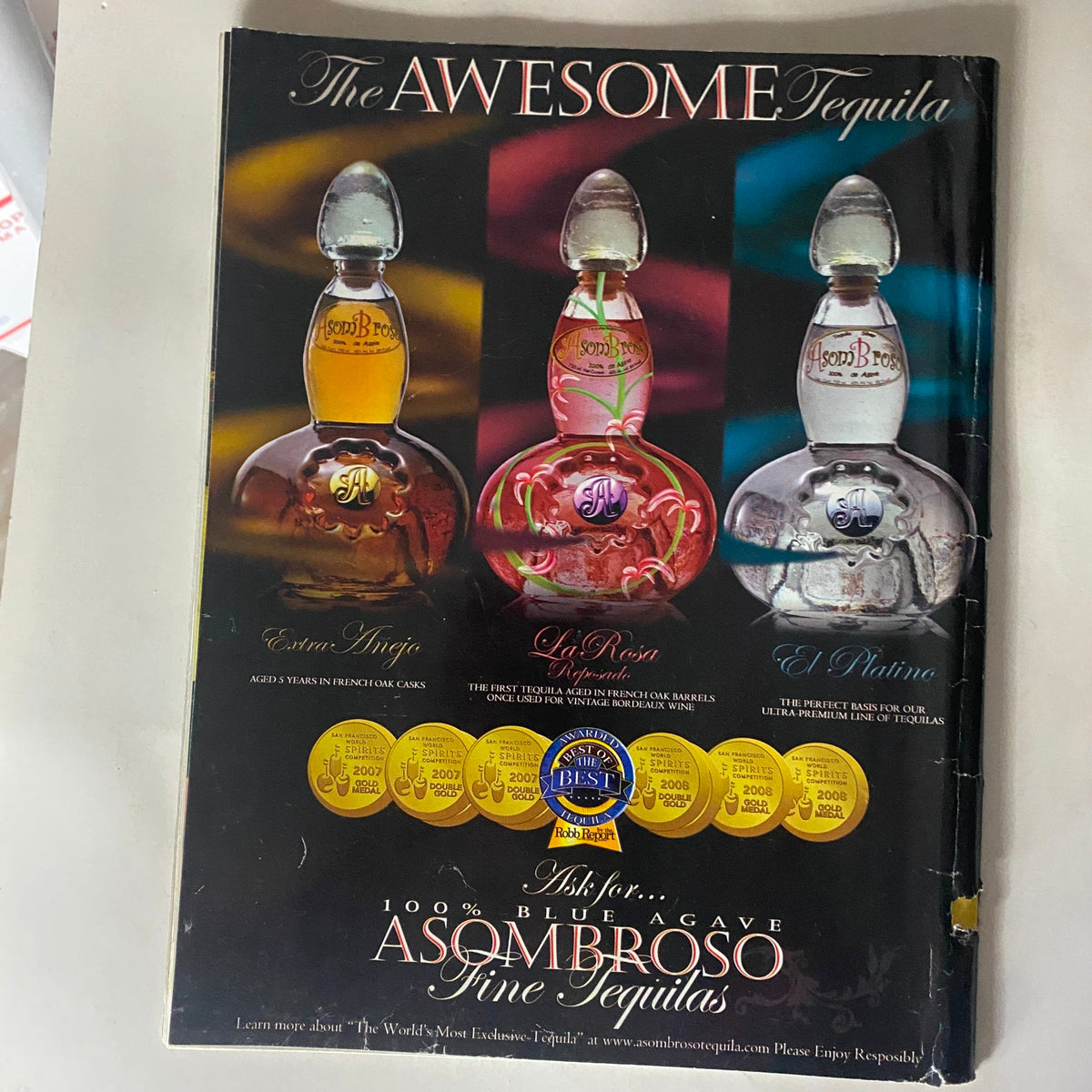 Back cover of Gladiator Magazine Issue No. 8 displaying an advertisement for Asombroso Tequila, emphasizing its fine quality and award-winning status.