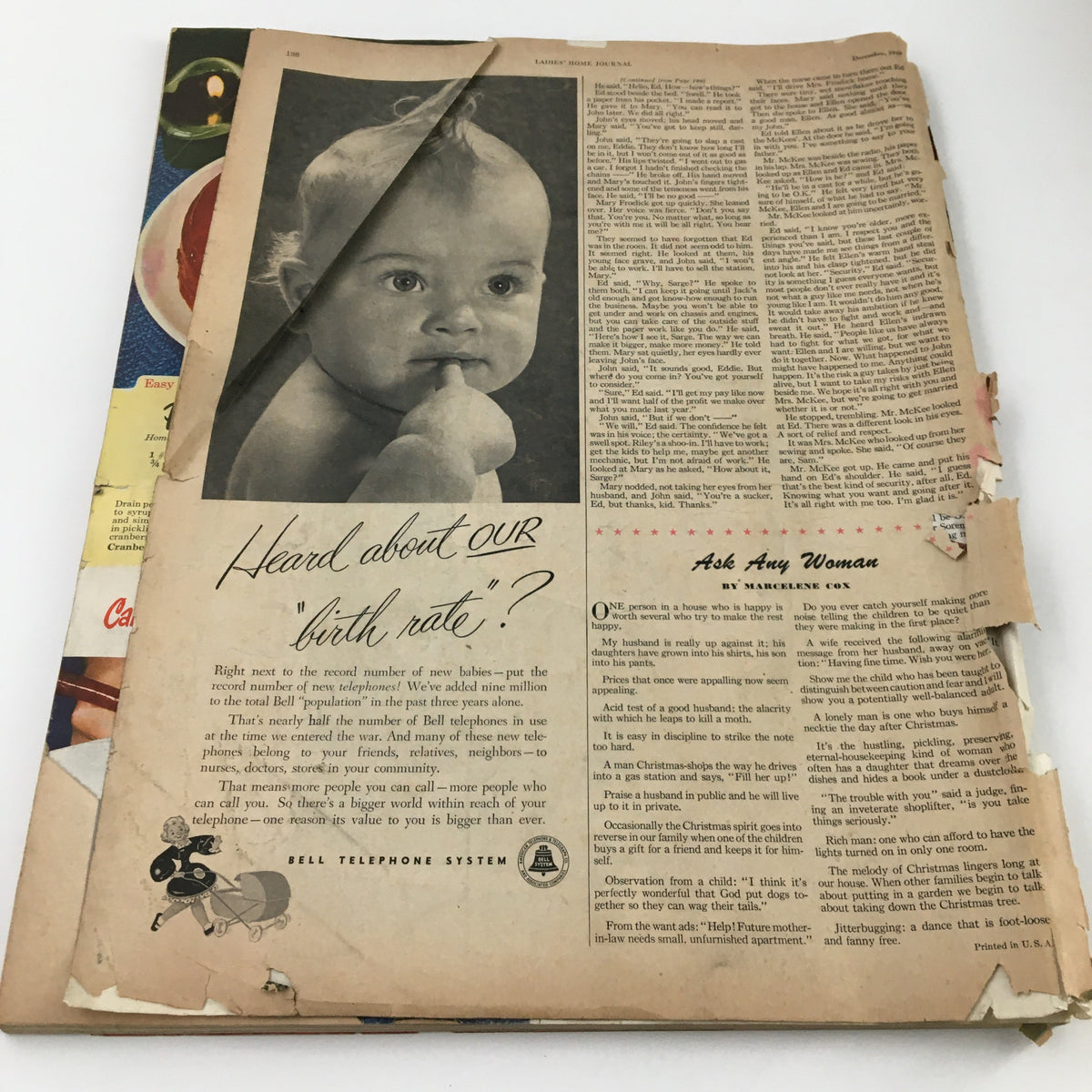 Ladies' Home Journal Magazine December 1948 featuring baby advertisement and an article page; shows vintage design and wear, suitable for collectors and enthusiasts of retro magazines.