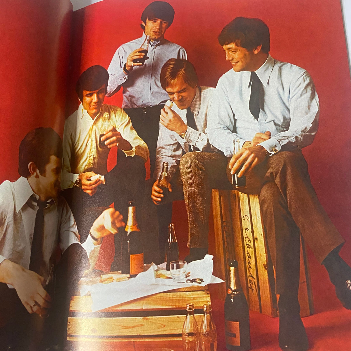Image from Teen Set Magazine November 1966 Vol. 2 No. 6 featuring a group of five men in stylish attire, enjoying drinks in a relaxed setting. The magazine highlights Bob Dylan and includes various pop culture elements from the mid-1960s.