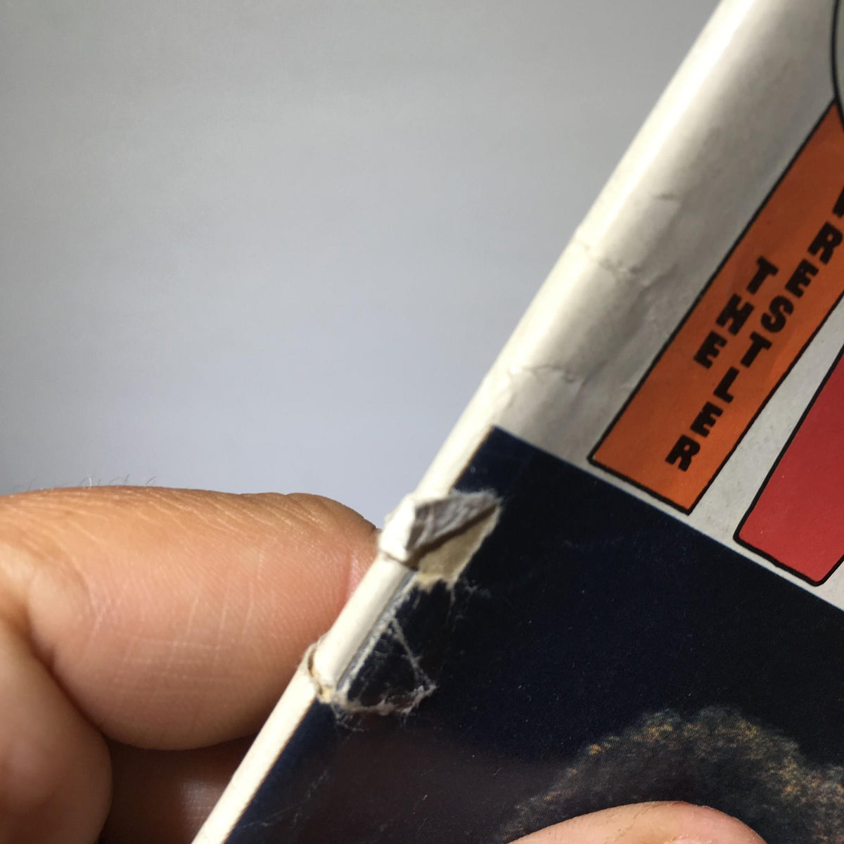Detailed view of damage on The Wrestler Magazine July 1976 spine, highlighting the vintage condition of this magazine featuring wrestling legends Andre the Giant & Ivan Putski.