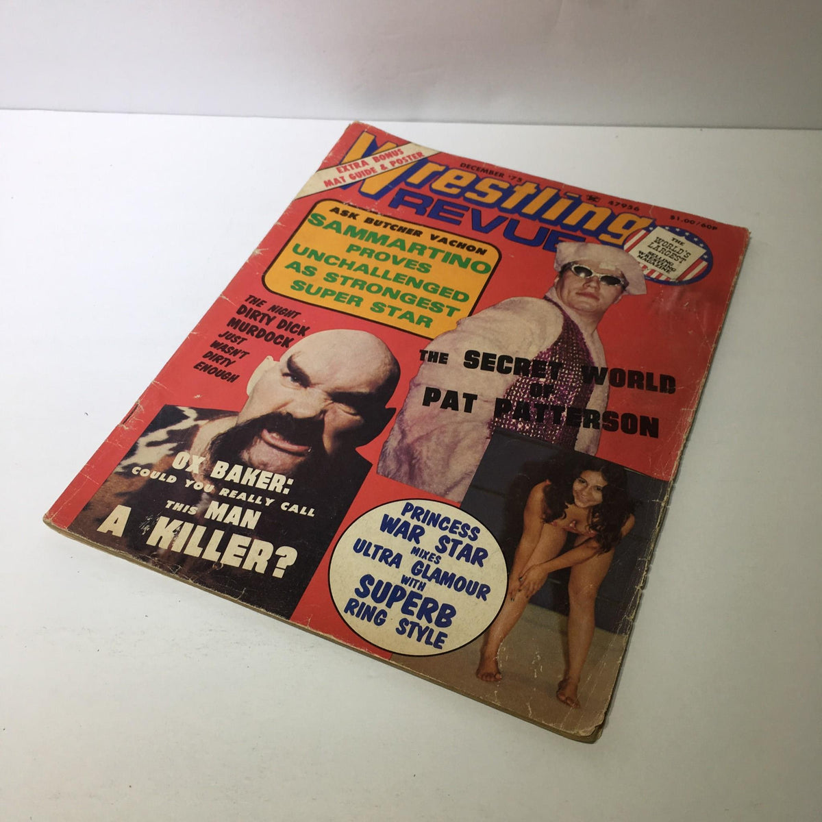 Wrestling Revue Magazine December 1975 featuring Bruno Sammartino and Ox Baker on the cover, showcasing vibrant graphics and text highlighting wrestling themes. The magazine is in good condition with mild wear and kept in a pet-free, smoke-free home.