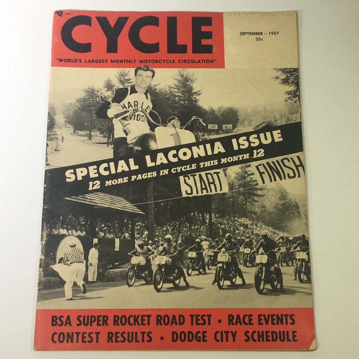 Cover of VTG Cycle Magazine September 1957 featuring BSA Super Rocket Road Test and Special Laconia Issue. Showcases a vintage motorcycle event with riders at the starting line and a man holding a trophy.